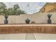 Landscaped backyard with planters and retaining wall offering a private outdoor space at 9611 Trattoria St, Las Vegas, NV 89178