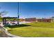 Community park featuring a basketball court, activity walls, picnic seating, and an expansive lawn area at 9611 Trattoria St, Las Vegas, NV 89178