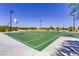 Community basketball courts with green surfaces, surrounded by landscaping and walking paths at 9611 Trattoria St, Las Vegas, NV 89178