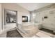 Spa-like bathroom with a tub, a shower, a fireplace, and tile surround at 9611 Trattoria St, Las Vegas, NV 89178