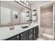 Modern bathroom with double sinks, a large mirror, and a separate shower area at 9611 Trattoria St, Las Vegas, NV 89178