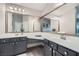 Bathroom features dual sinks and a vanity with an oversized mirror at 9611 Trattoria St, Las Vegas, NV 89178