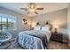 Bedroom showcasing a comfortable bed, ceiling fan, and a sunny window at 9611 Trattoria St, Las Vegas, NV 89178
