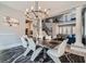 Open-concept dining area with modern chandelier, statement art, and views of the second-story loft at 9611 Trattoria St, Las Vegas, NV 89178