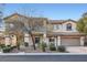 Two-story home featuring manicured landscaping and a two-car garage at 9611 Trattoria St, Las Vegas, NV 89178