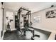 Well-equipped home gym with weights, weight rack, and adjustable bench for a complete workout at 9611 Trattoria St, Las Vegas, NV 89178