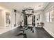 Home gym with a weight rack, bench, mirror, and rubber floor at 9611 Trattoria St, Las Vegas, NV 89178