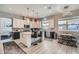 Stylish kitchen featuring an island with seating, modern stainless appliances, and elegant pendant lighting at 9611 Trattoria St, Las Vegas, NV 89178