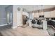Bright kitchen boasts an island with breakfast bar, stainless appliances, white cabinets, and tile backsplash at 9611 Trattoria St, Las Vegas, NV 89178