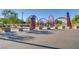 Inviting park entrance with decorative metal arches and signage amid walking paths and shaded seating areas at 9611 Trattoria St, Las Vegas, NV 89178