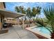 Beautiful backyard featuring a sparkling pool, covered patio, and lush landscaping, perfect for outdoor living at 9992 Oyster Pearl St, Las Vegas, NV 89183
