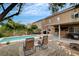 Inviting backyard featuring a pool, patio, fire pit, and shaded lounge area at 9992 Oyster Pearl St, Las Vegas, NV 89183