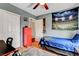 A bright bedroom featuring closet, stadium tapestry, and updated flooring at 9992 Oyster Pearl St, Las Vegas, NV 89183