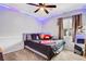 Charming bedroom with a ceiling fan, cozy carpet, and plush pillows decorating the bed at 9992 Oyster Pearl St, Las Vegas, NV 89183