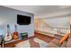 Bedroom with hardwood floors, television, and access to upstairs hallway at 9992 Oyster Pearl St, Las Vegas, NV 89183