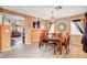 Open-concept dining area with tile flooring, seating and an adjacent living room at 9992 Oyster Pearl St, Las Vegas, NV 89183