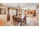 Bright dining room with tile floors and a wooden dining set, adjacent to the kitchen at 9992 Oyster Pearl St, Las Vegas, NV 89183