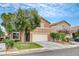 Exterior view of a two-story house with a two-car garage and a well-maintained lawn at 9992 Oyster Pearl St, Las Vegas, NV 89183