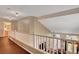 Open hallway with wood floors, white banister, and views of the downstairs entry and a full bathroom at 9992 Oyster Pearl St, Las Vegas, NV 89183