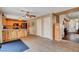 Open-concept kitchen with breakfast bar seating, wooden cabinets, stainless appliances, and tile flooring at 9992 Oyster Pearl St, Las Vegas, NV 89183