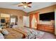 Spacious main bedroom with mirrored closet, dresser with TV and doorway view to the en suite bathroom at 9992 Oyster Pearl St, Las Vegas, NV 89183