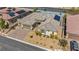 Aerial view of house with a three-car garage, desert landscaping, and solar panels at 10062 Mountain Foothills Ave, Las Vegas, NV 89149