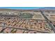 An aerial view of a community and surrounding landscape with a view of a track and field at 10062 Mountain Foothills Ave, Las Vegas, NV 89149