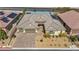 Aerial view of home with solar panels, 3-car garage, and desert landscaping at 10062 Mountain Foothills Ave, Las Vegas, NV 89149