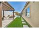 Secluded backyard oasis with a pergola, artificial turf, and sparkling pool, ideal for relaxation and entertainment at 10062 Mountain Foothills Ave, Las Vegas, NV 89149