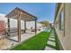 Beautiful backyard featuring a pergola, artificial grass, and pristine pool, perfect for outdoor enjoyment at 10062 Mountain Foothills Ave, Las Vegas, NV 89149