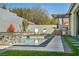 Backyard with pool, outdoor kitchen, covered seating area, and manicured landscaping at 10062 Mountain Foothills Ave, Las Vegas, NV 89149