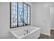 Elegant bathroom featuring a soaking tub beneath a beautiful Japanese-style screen at 10062 Mountain Foothills Ave, Las Vegas, NV 89149
