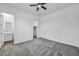 Spacious carpeted bedroom with a ceiling fan, an en-suite bathroom, and closet access at 10062 Mountain Foothills Ave, Las Vegas, NV 89149