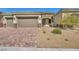Picture-perfect single-story home with a three-car garage and tidy desert landscaping at 10062 Mountain Foothills Ave, Las Vegas, NV 89149