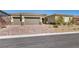 Lovely single-story home featuring a three-car garage and appealing desert landscaping at 10062 Mountain Foothills Ave, Las Vegas, NV 89149