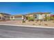 Attractive single-story home with a three-car garage and neat desert landscaping at 10062 Mountain Foothills Ave, Las Vegas, NV 89149