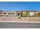 Inviting single-story home with a three-car garage and easy-care desert landscaping at 10062 Mountain Foothills Ave, Las Vegas, NV 89149