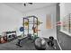 Bright home gym with modern equipment and a serene view from the window at 10062 Mountain Foothills Ave, Las Vegas, NV 89149
