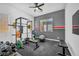 Well-equipped home gym with weightlifting rack, bench, and rubber flooring for safe workouts at 10062 Mountain Foothills Ave, Las Vegas, NV 89149