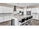 Modern kitchen with marble countertops, an island with seating, and stainless steel appliances at 10062 Mountain Foothills Ave, Las Vegas, NV 89149