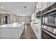 Modern kitchen features an island with a sink, stainless appliances, ample counter space, and backyard access at 10062 Mountain Foothills Ave, Las Vegas, NV 89149