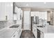 A well-equipped kitchen features stainless steel appliances, white cabinets, marble countertops, and lots of storage at 10062 Mountain Foothills Ave, Las Vegas, NV 89149