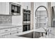 Modern kitchen features stainless steel appliances, marble countertops, and a pantry at 10062 Mountain Foothills Ave, Las Vegas, NV 89149