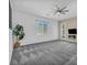 Spacious living room featuring neutral carpet, a ceiling fan and ample natural light at 10062 Mountain Foothills Ave, Las Vegas, NV 89149