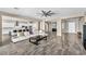 Bright, open concept living room featuring modern tile flooring, backyard views, and access to the kitchen at 10062 Mountain Foothills Ave, Las Vegas, NV 89149