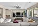 Spacious living room featuring an oversized sectional sofa, dark entertainment center, and backyard views at 10062 Mountain Foothills Ave, Las Vegas, NV 89149