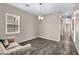 Bright, airy living room with neutral walls, modern chandelier, and stylish wood-look tile flooring at 10062 Mountain Foothills Ave, Las Vegas, NV 89149