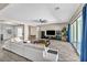 Open living room with modern decor, tile floors, and sliding glass doors leading to the backyard at 10062 Mountain Foothills Ave, Las Vegas, NV 89149