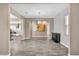 Open-concept living area with modern chandelier, neutral colors, and a glimpse of the kitchen at 10062 Mountain Foothills Ave, Las Vegas, NV 89149