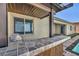 Outdoor kitchen with built-in grill and bar seating adjacent to the swimming pool at 10062 Mountain Foothills Ave, Las Vegas, NV 89149